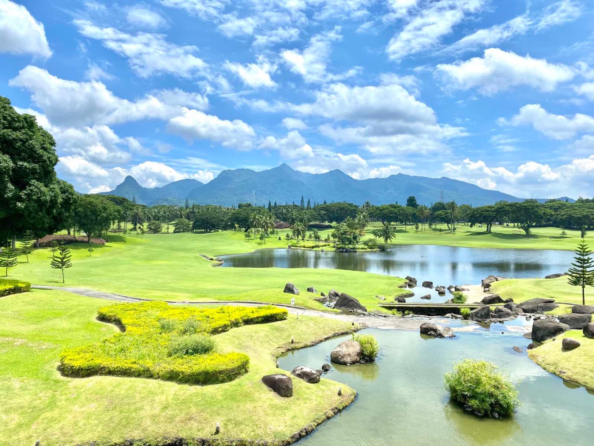 Golf course lake and rock garden with mountain views at Mount Malarayat (photo)