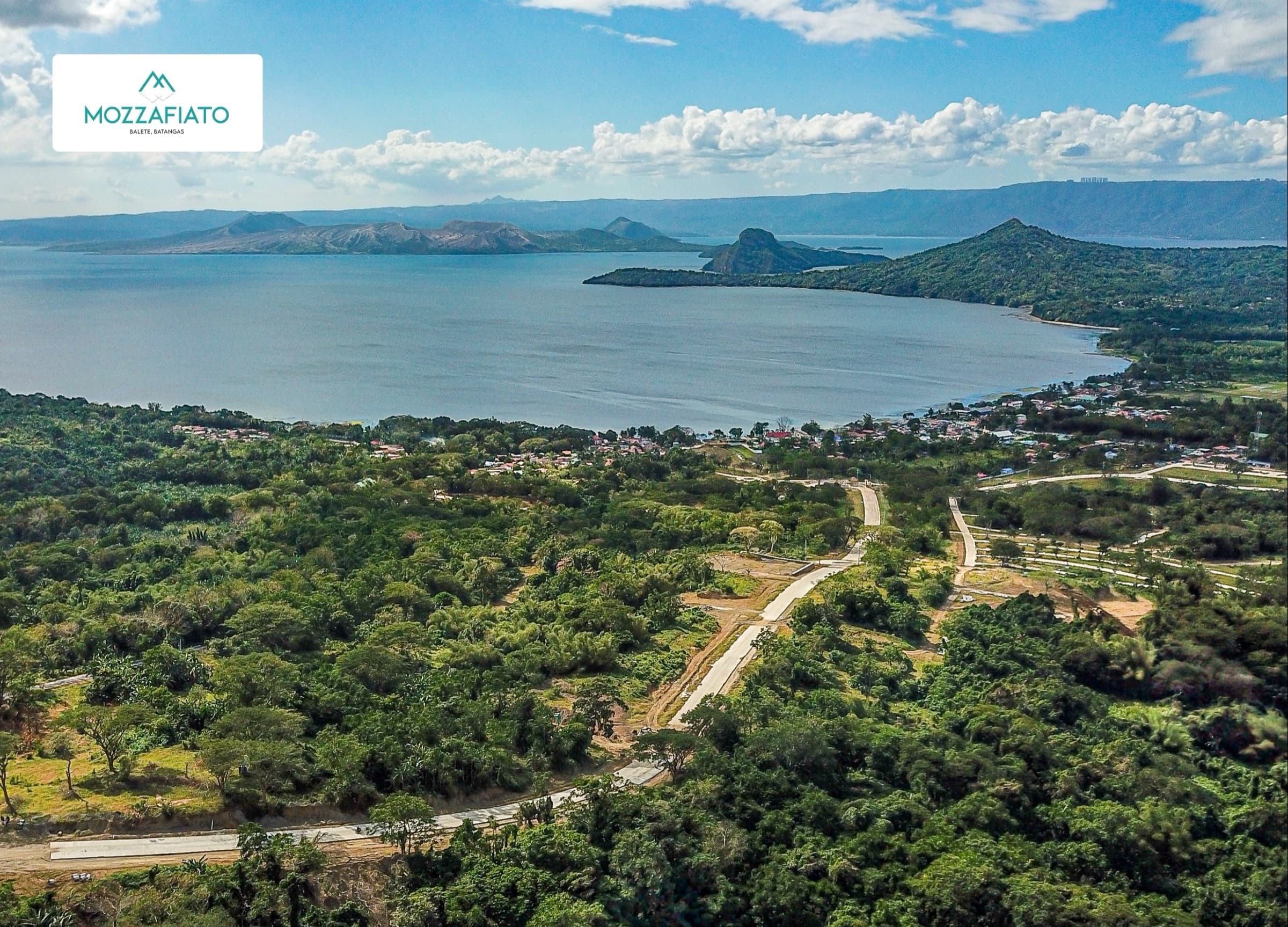 Aerial view of the estate's roads winding through greenery toward the Taal Lake cove
